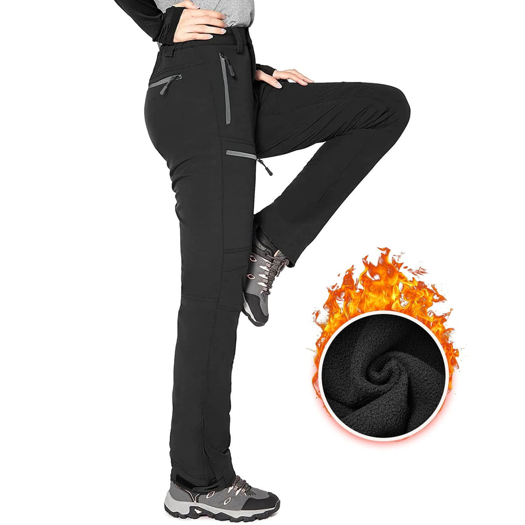 Women's snow pants in black, fleece lined softshell ski pants with zip pockets