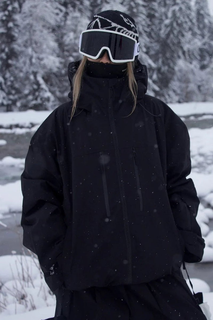 Woman wearing the black oversized ski jacket in a snowy forest