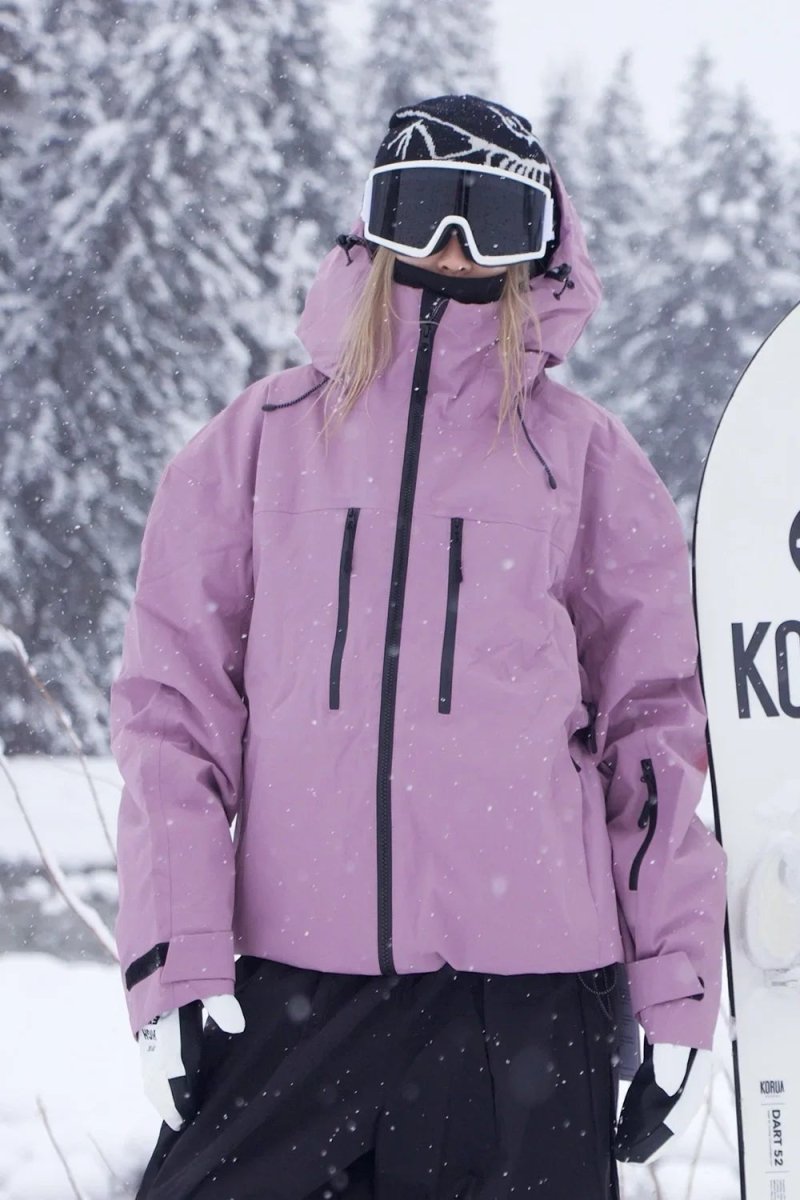 Pink hooded snowboard jacket worn next to a snowboard