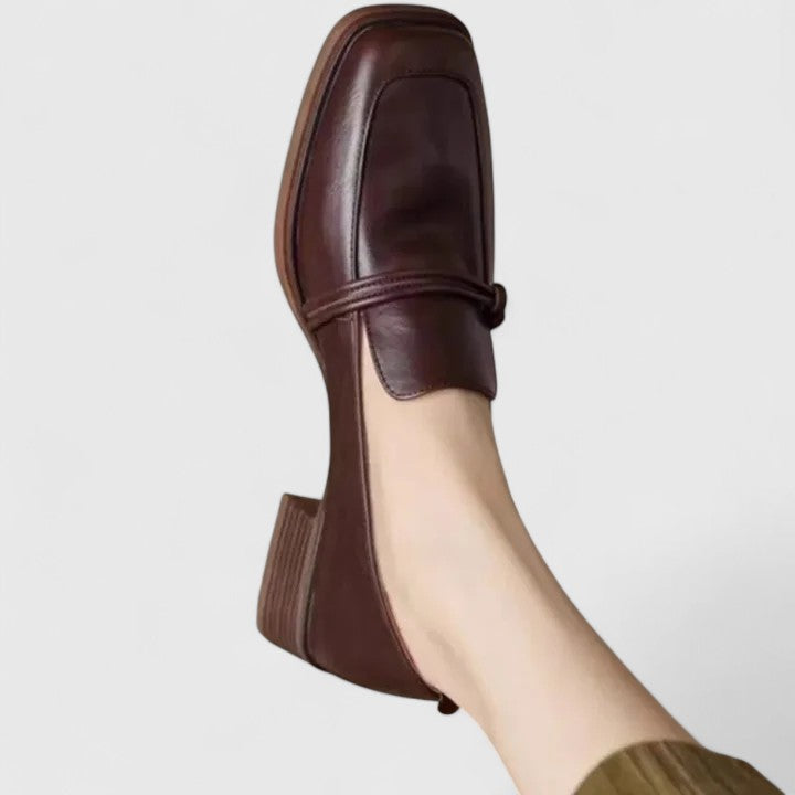 Oxblood low block heel loafer with penny strap, side view on foot