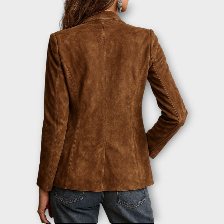 Back view of the brown vintage blazer on a model with hand in pocket