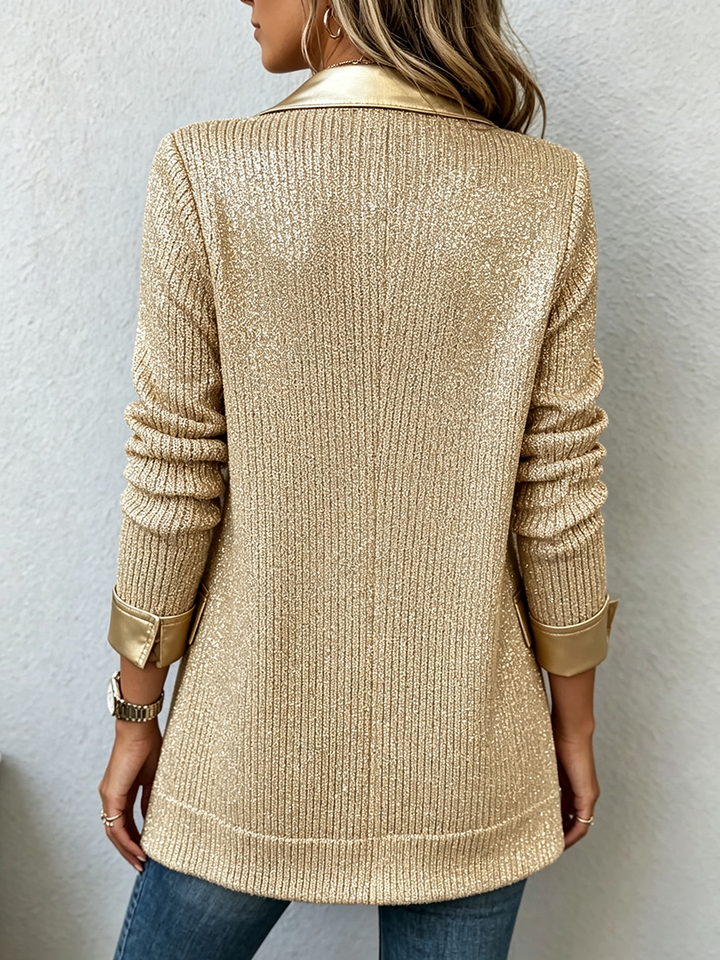 Back view of the gold sweater blazer showing the ribbed knit and turned-back cuffs