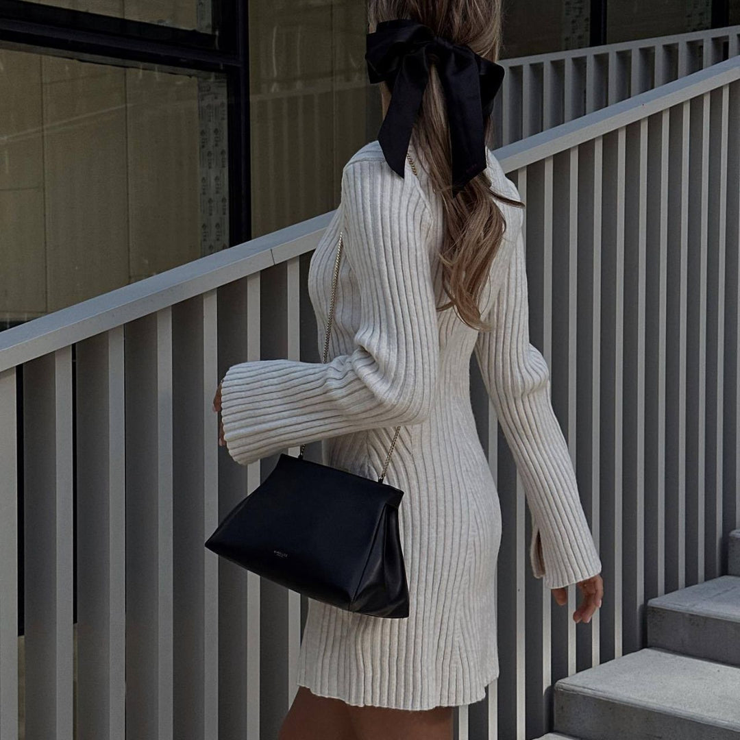 Back view of the ivory ribbed sweater dress with flared sleeves