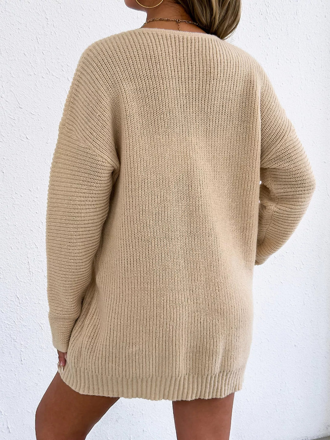 Back view of the beige ribbed knit dress with long sleeves