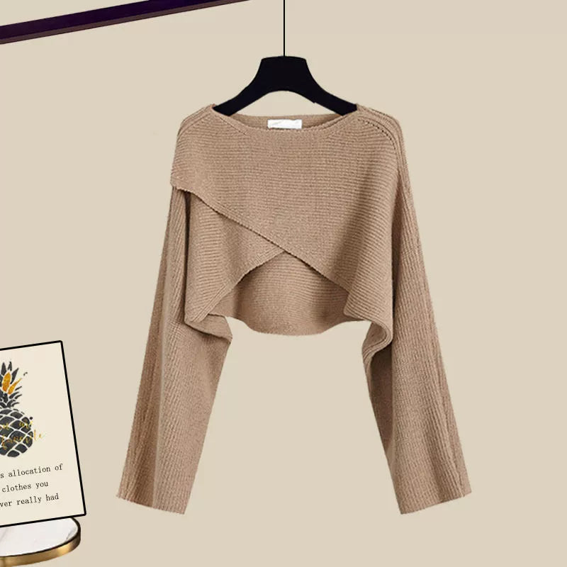 Camel cropped sweater with crossover front, shown on hanger