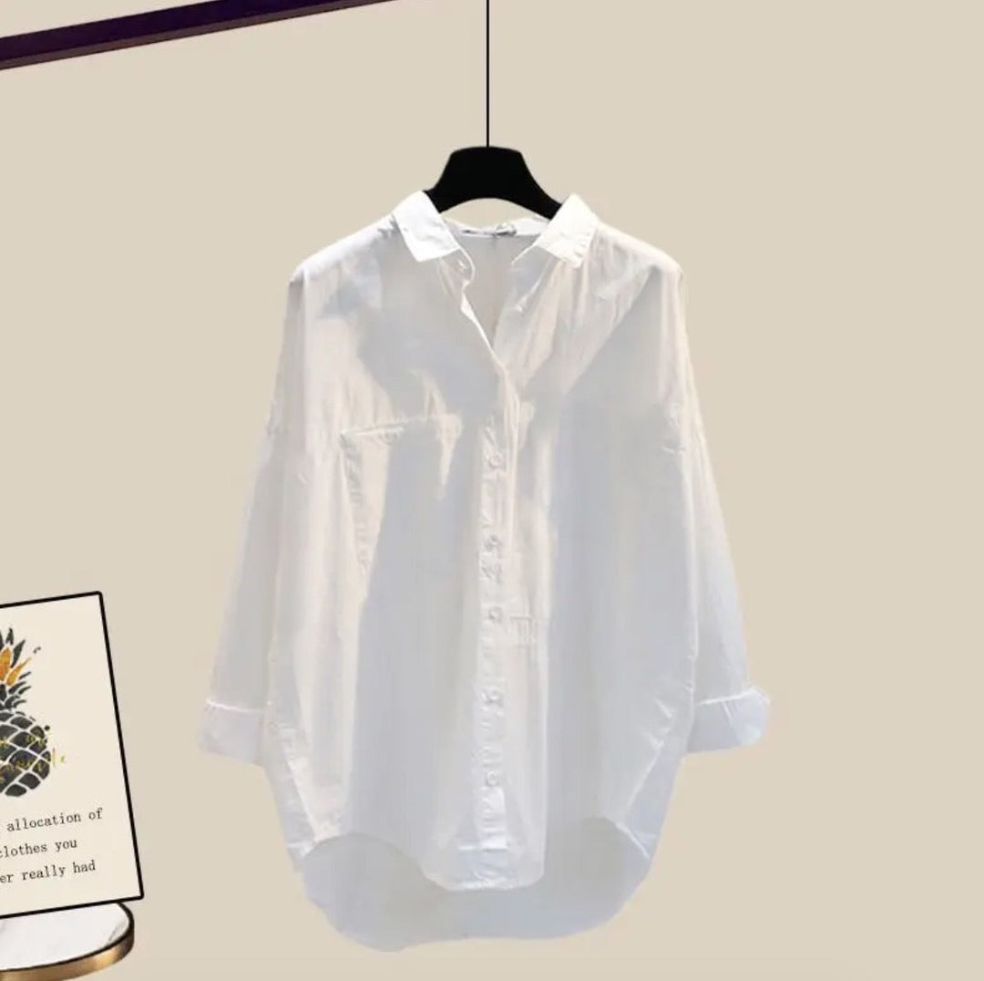 White collared shirt with chest pocket and curved hem, front view on hanger