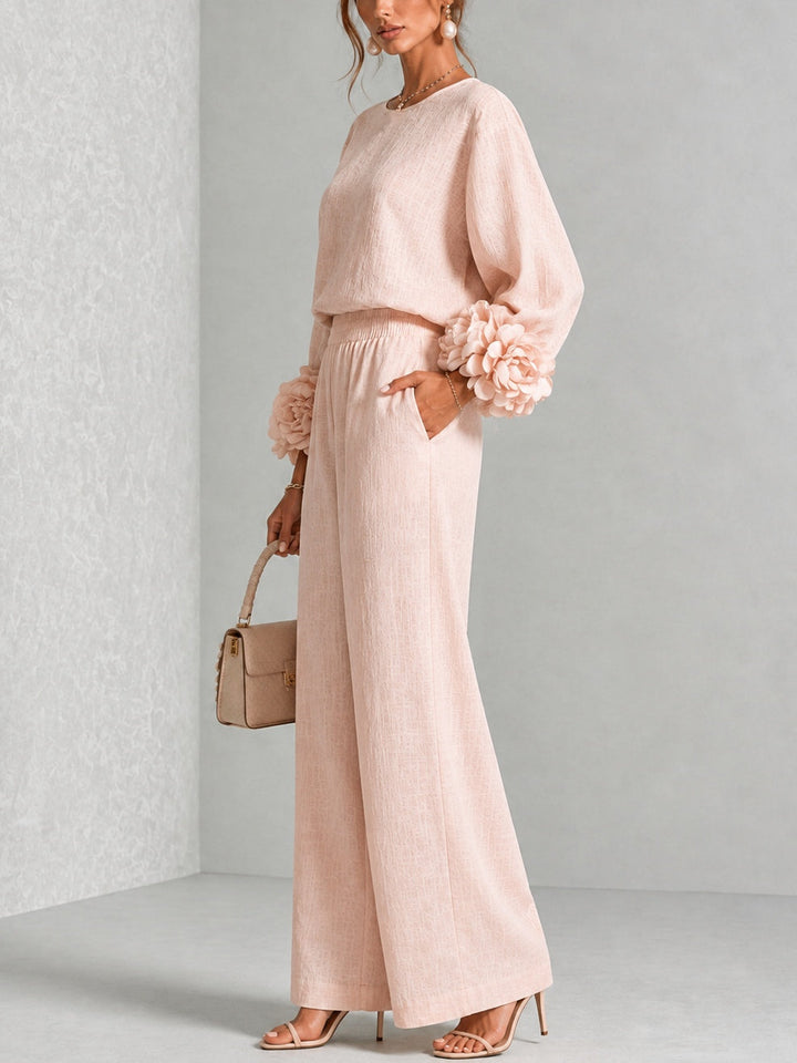Side view of pink sweater set showing the ruffled cuff and relaxed wide leg pants