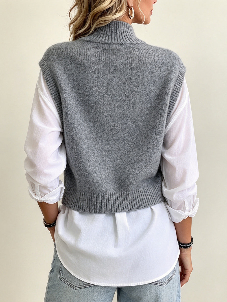 Back of the grey knit vest worn over the white shirt