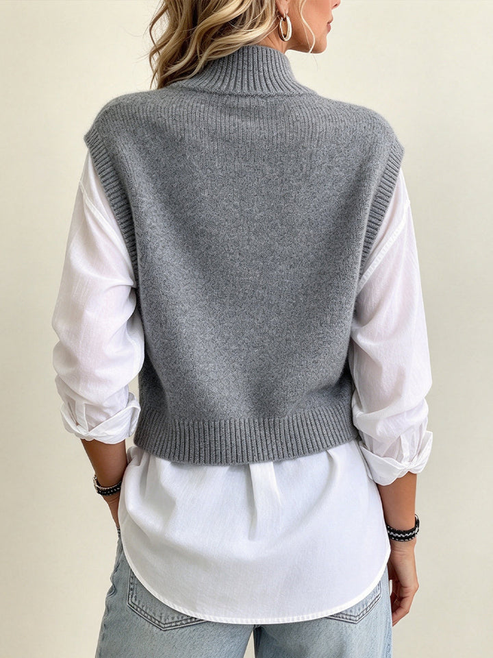 Back of the grey knit vest worn over the white shirt