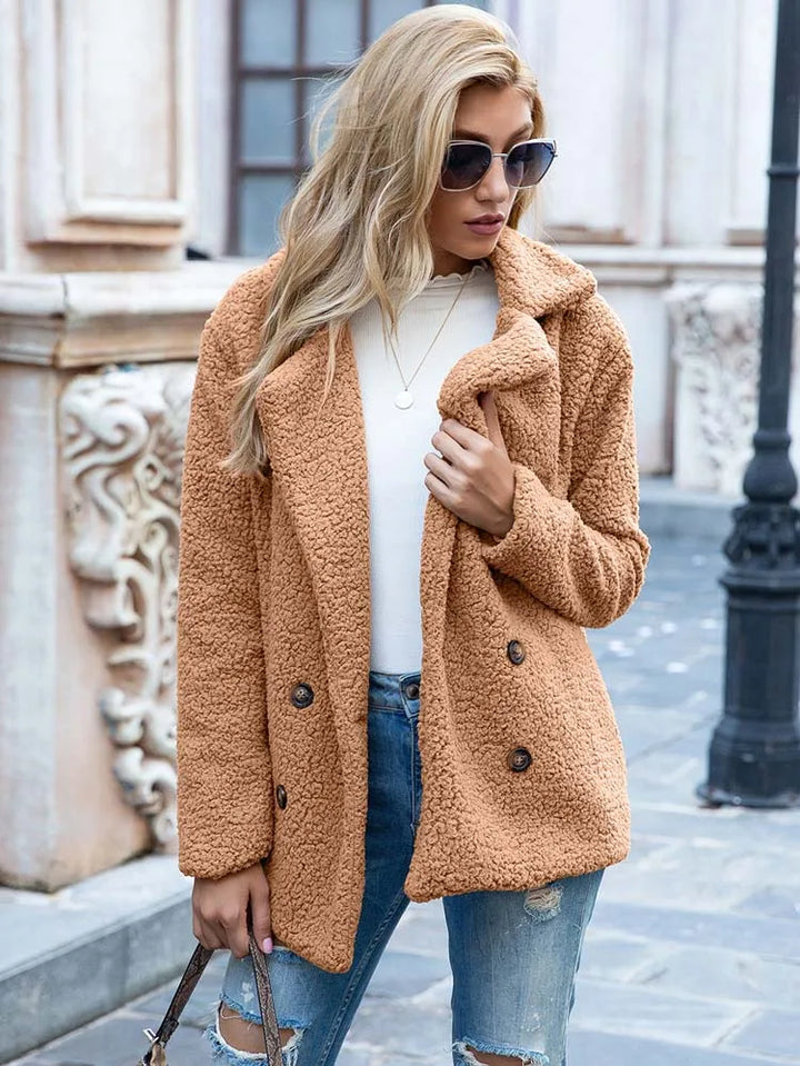 Woman wearing the camel double breasted hip length teddy coat with sunglasses outdoors