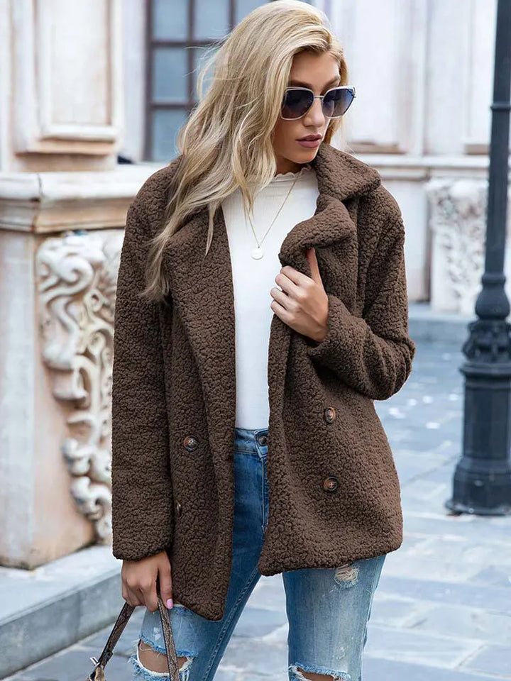 Coffee brown double breasted teddy coat with buttons, worn with a white top