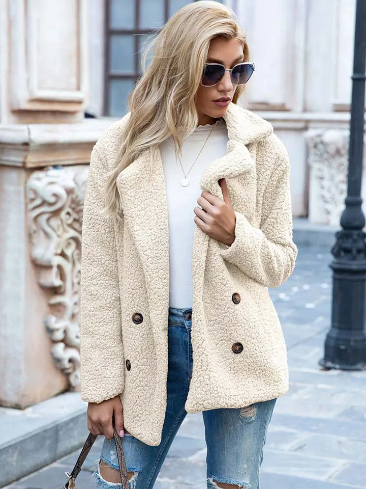 White teddy coat in cream tone, hip length and double breasted, styled with jeans