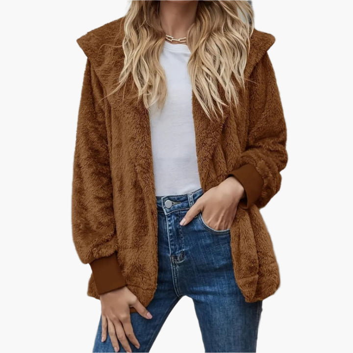 Brown plush jacket worn open over a white tee