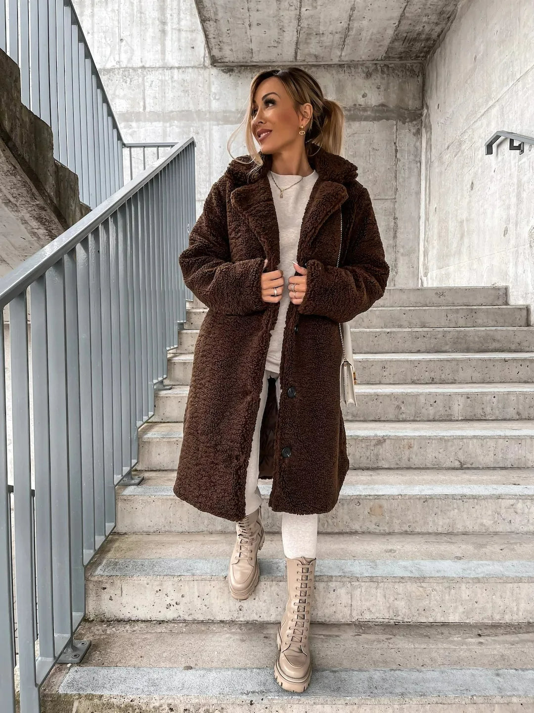 Chocolate brown teddy coat, front view with hands in the pockets