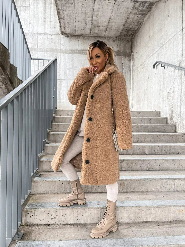 Full-length look at the tan teddy coat styled with lace-up boots
