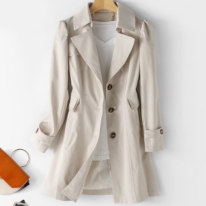 Beige classic trench coat with belted waist, shown with a handbag and shoes