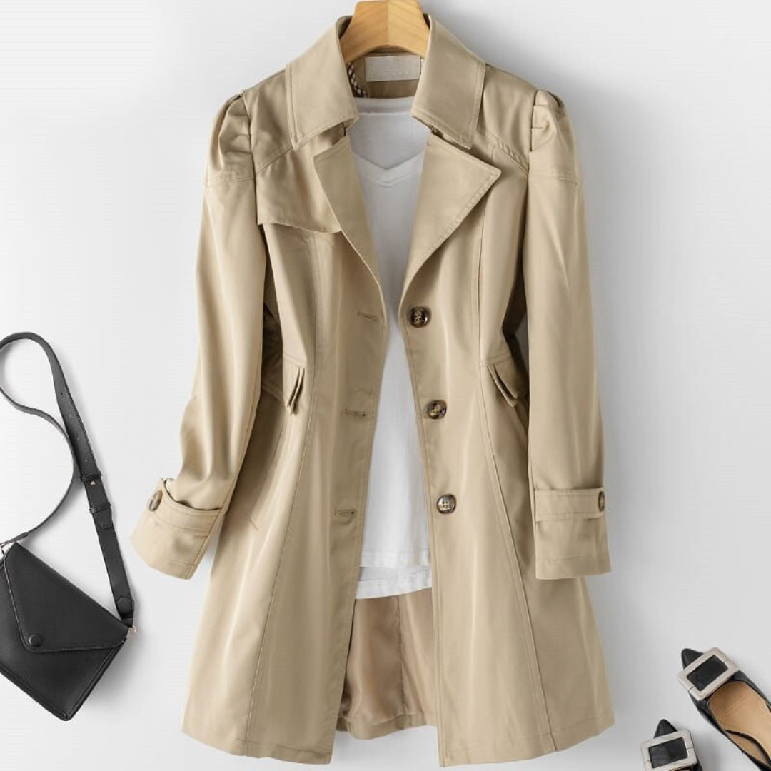 Women's khaki trench coat with button cuffs, front view with bag and flats