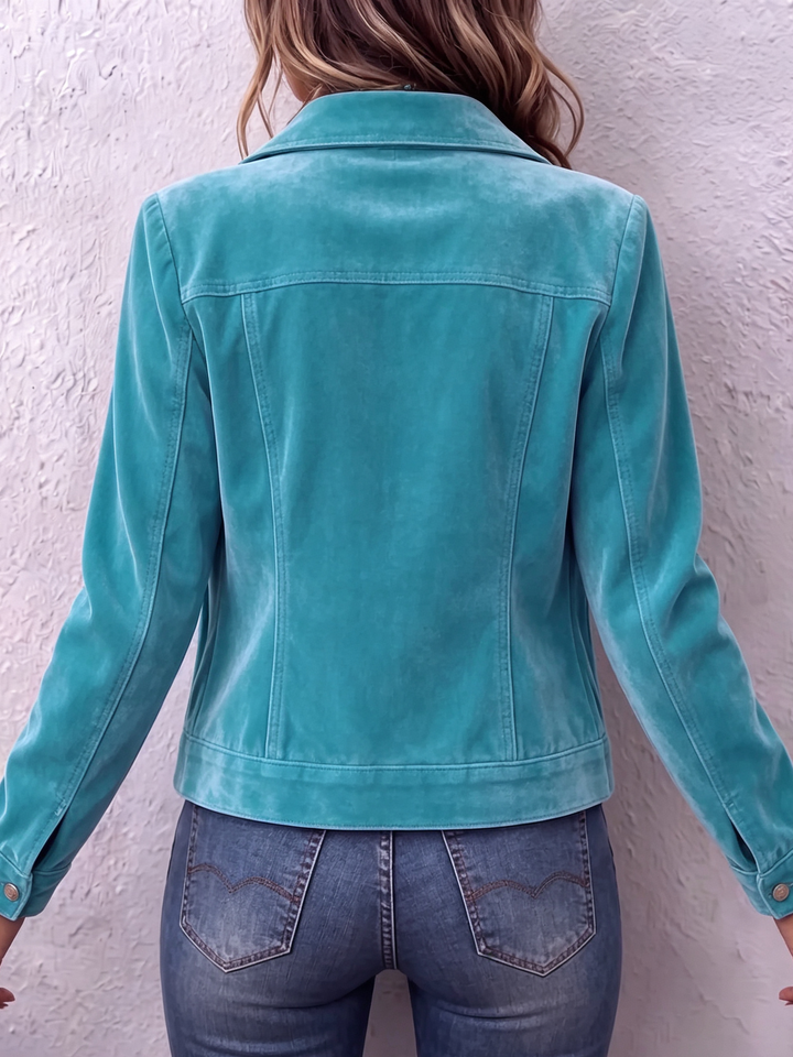 Back view of the teal jacket showing the fitted seams