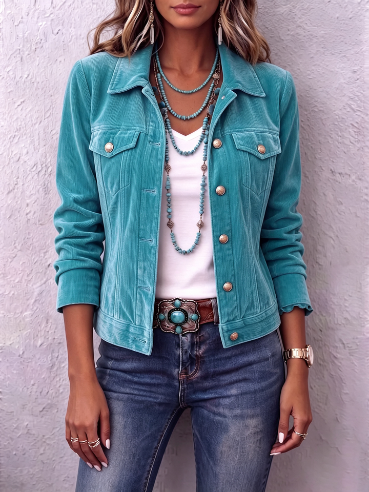Teal velvet-look jacket worn open with mid-wash denim and a turquoise belt buckle