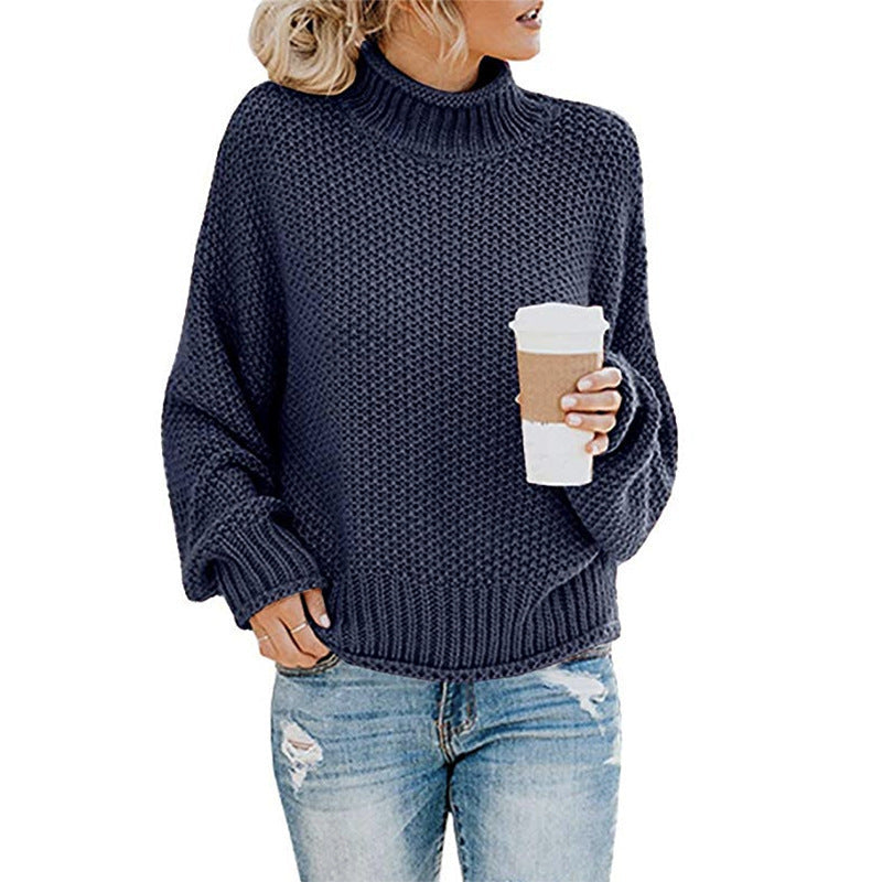 Navy chunky turtleneck worn with a coffee cup