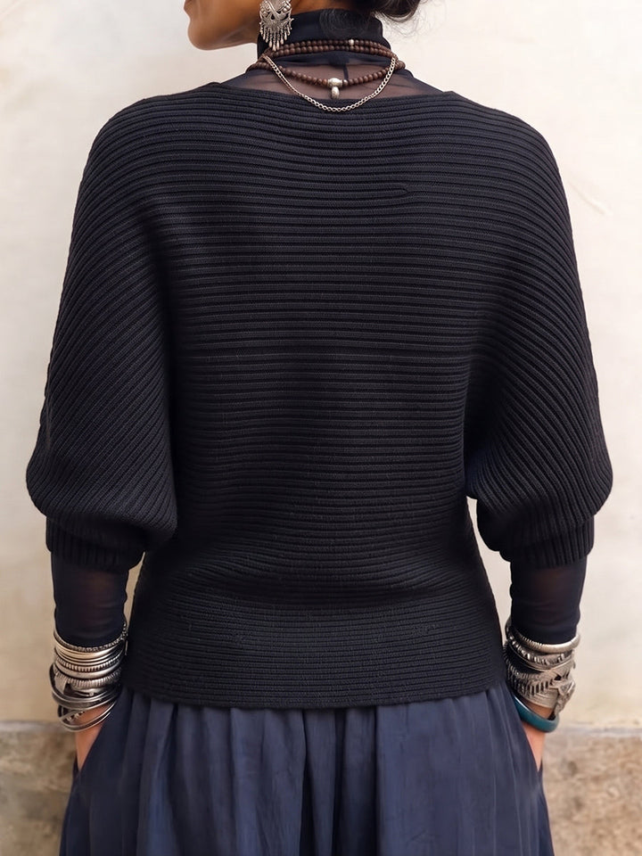Back view of the black batwing sweater with ribbed texture