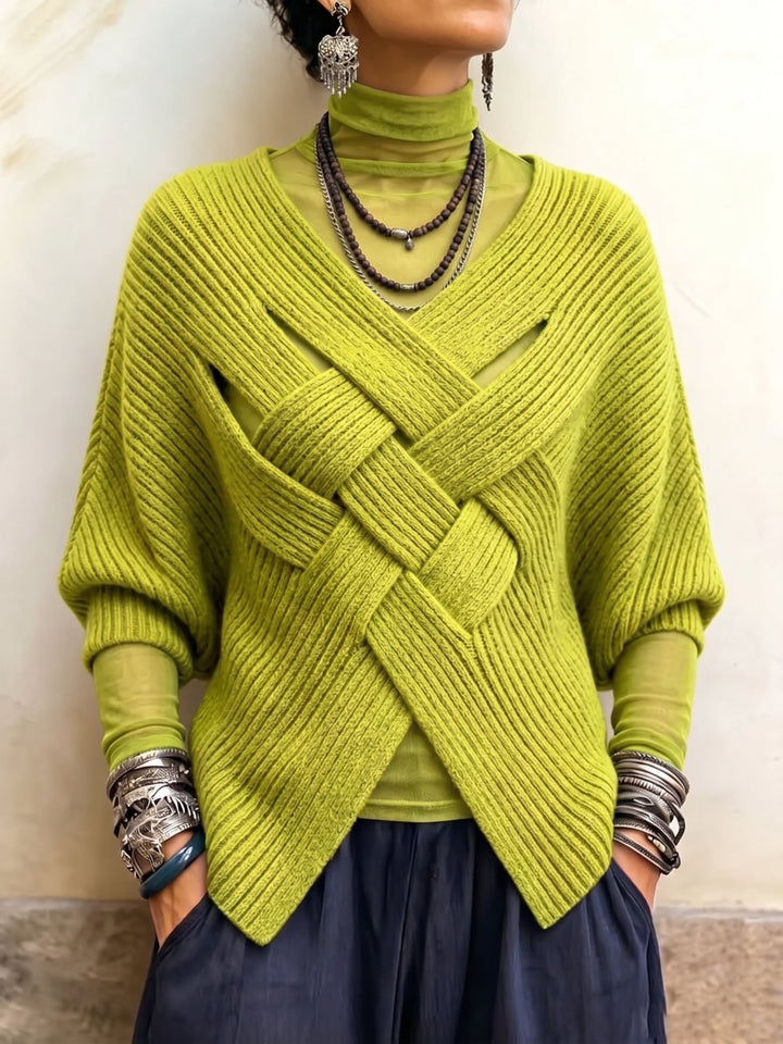 Lime ribbed sweater with braided cross bands layered over a sheer turtleneck