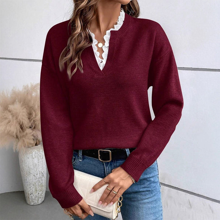 Burgundy lace trim V neck sweater styled with jeans and a cream clutch