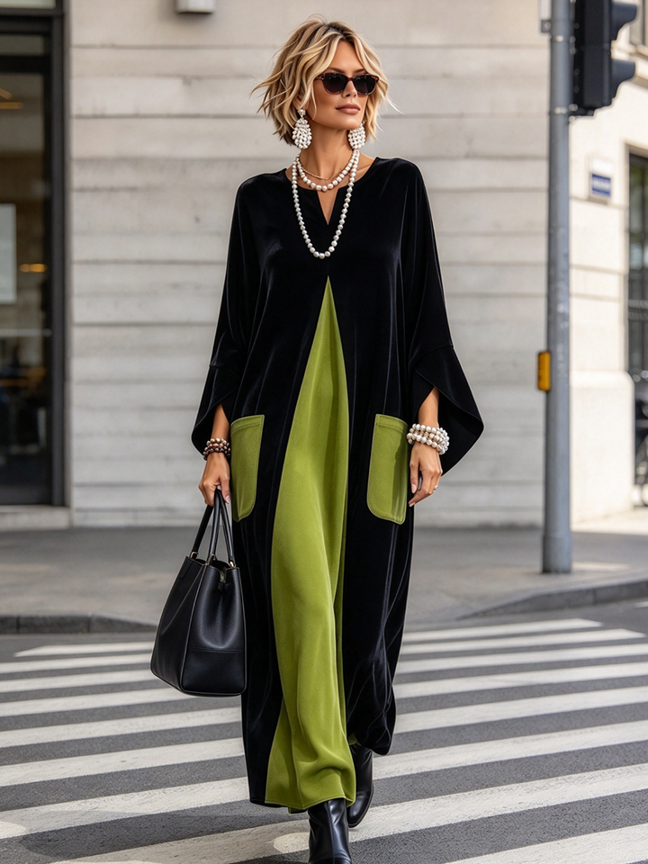 Woman crossing a street in the black maxi dress with green panel and patch pockets