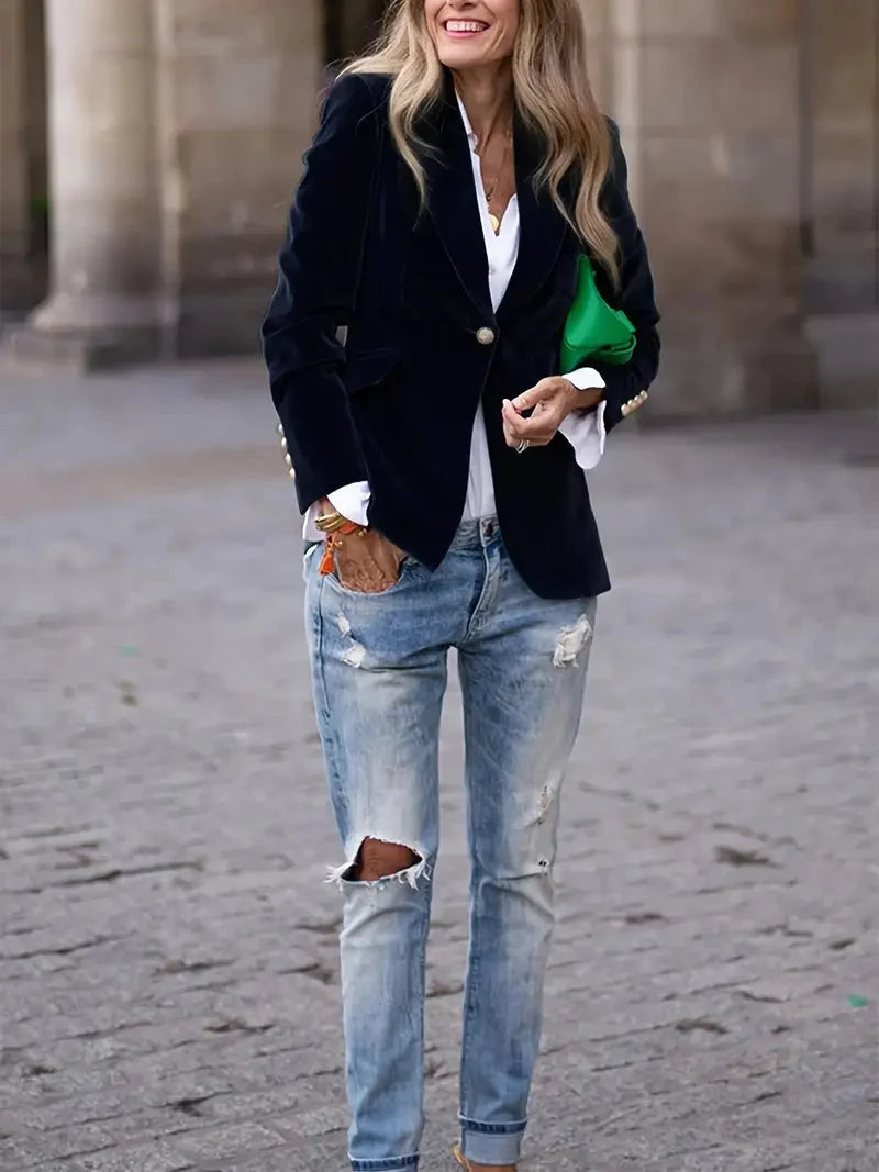 Black velvet-look blazer styled with a white shirt and distressed denim