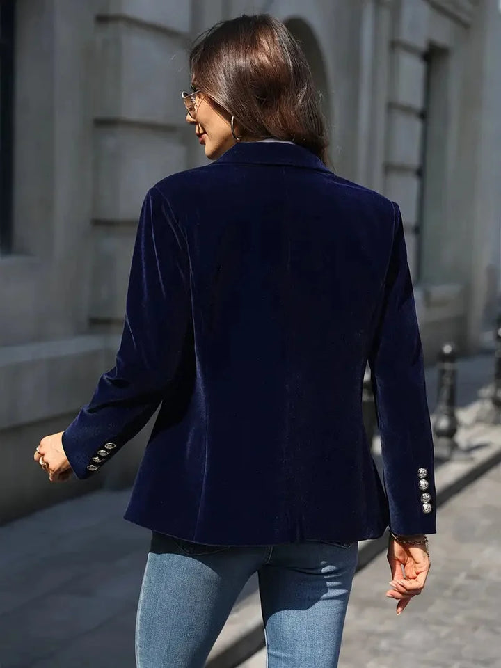 Back view of the navy blazer showing the fitted waist