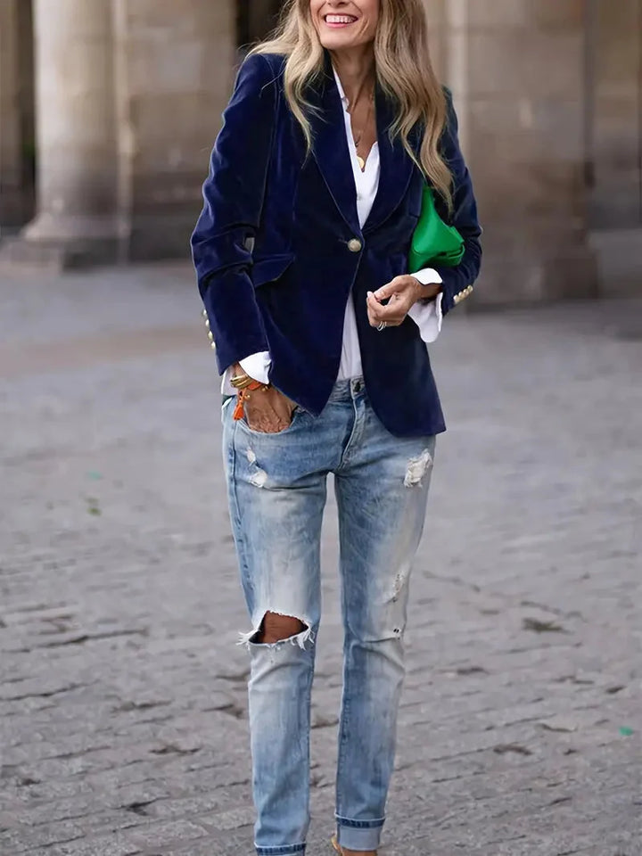Navy velvet-look blazer worn open over a white shirt