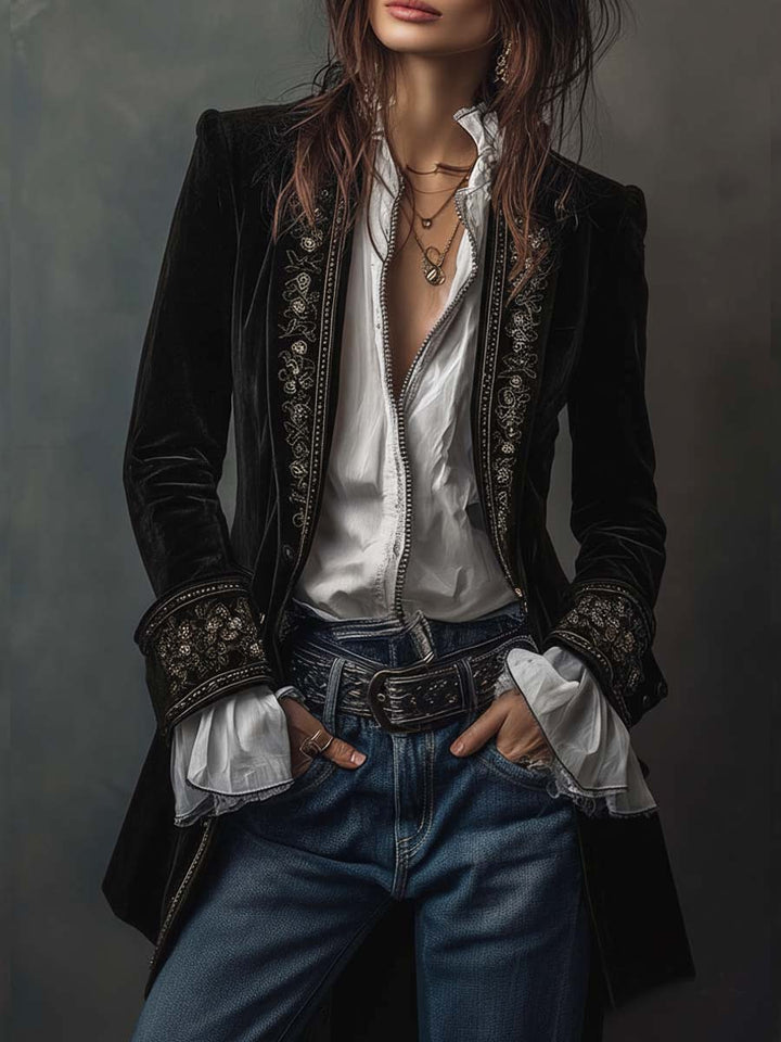 Black velvet-look long embroidered jacket, front view with white blouse and jeans