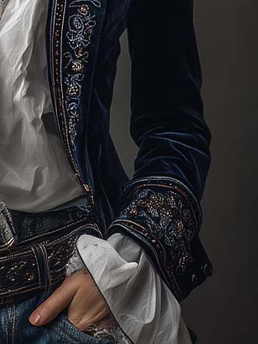 Embroidered cuff with white ruffle sleeve on the navy velvet-look jacket