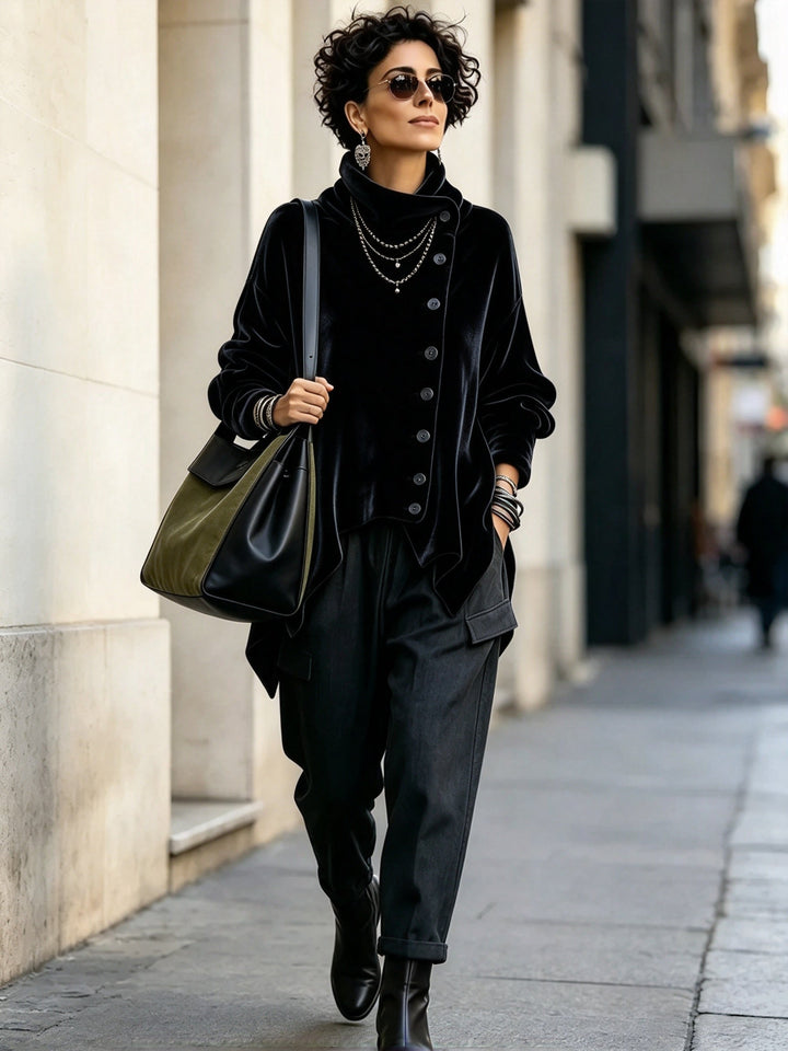 Black oversized turtleneck top worn with dark pants and ankle boots on the street