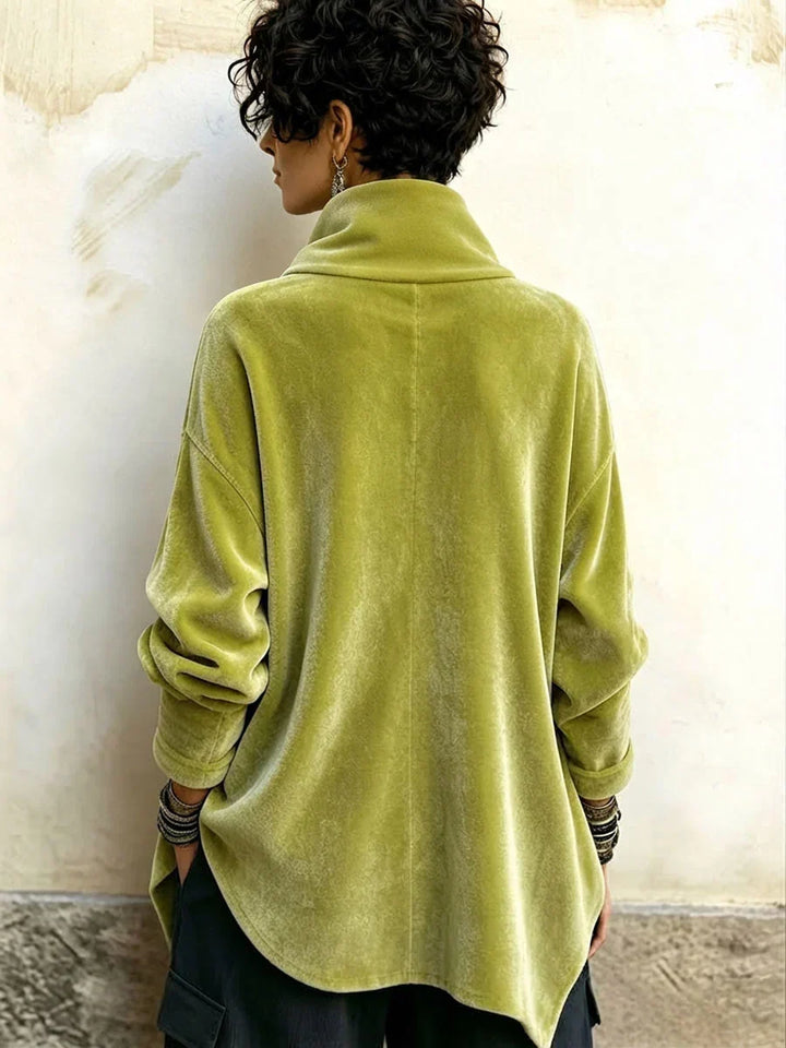 Back view of the olive green turtleneck top with a curved, longer back hem