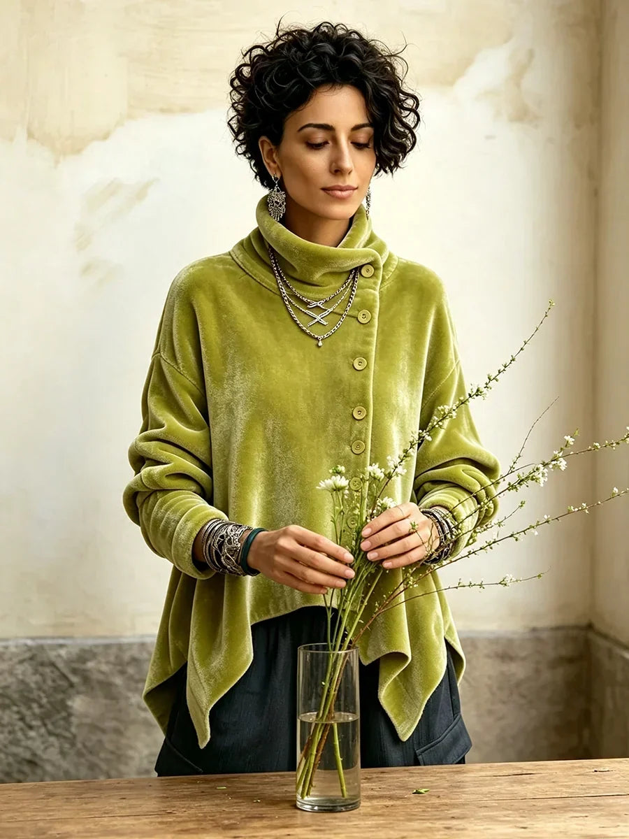 Olive green turtleneck top with off-center buttons, worn while arranging flowers