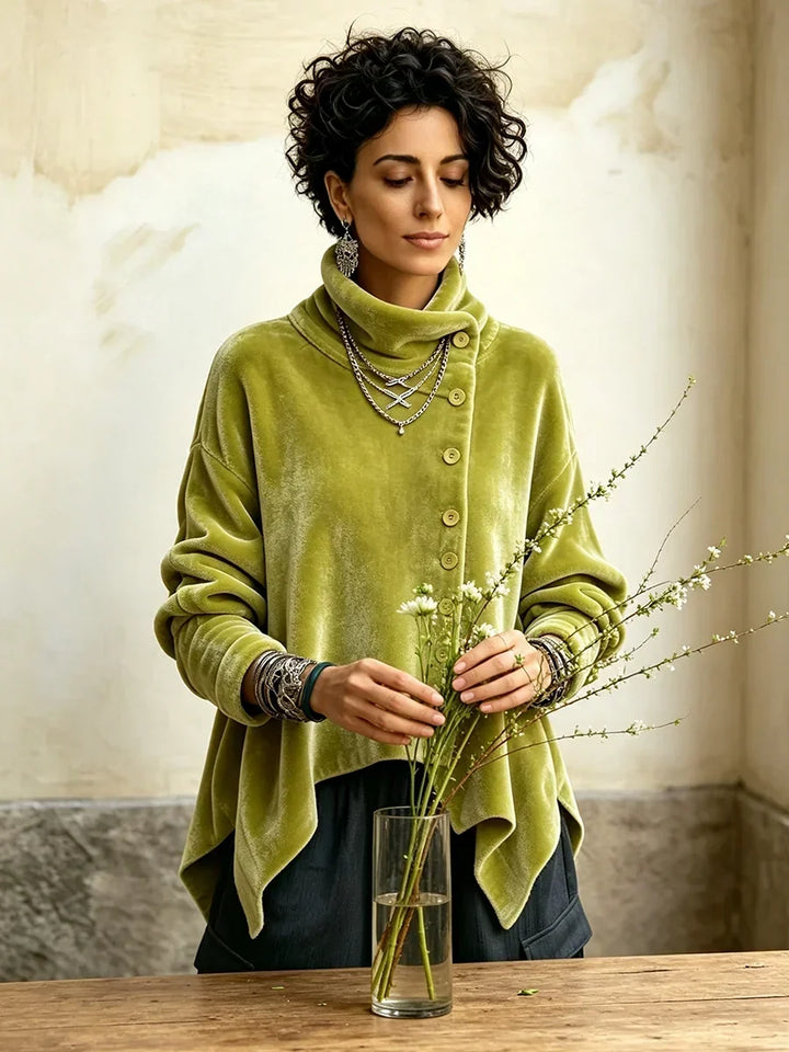 Olive green turtleneck top with off-center buttons, worn while arranging flowers