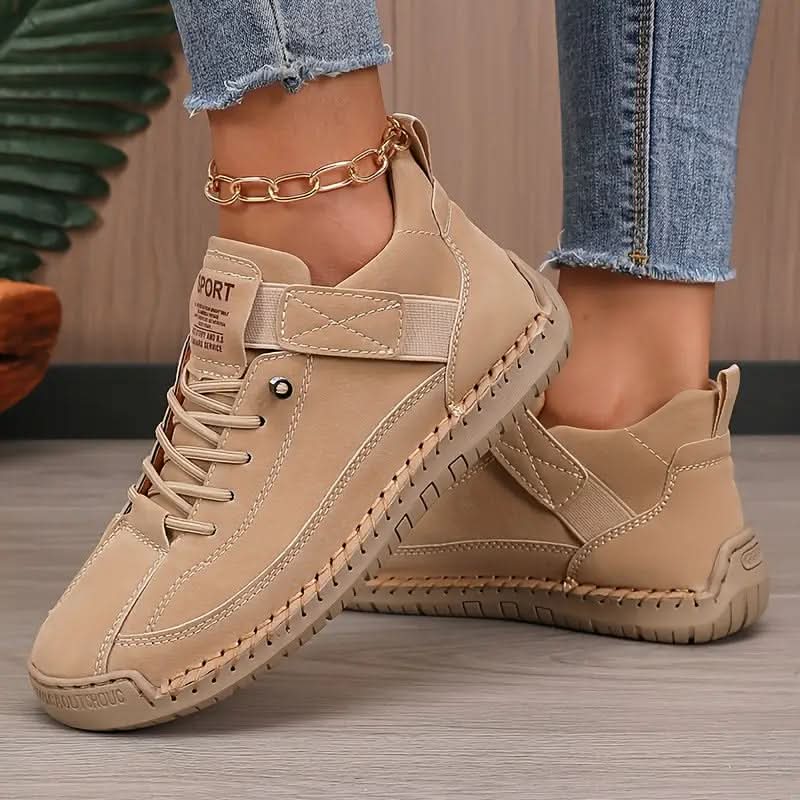 Beige sneakers with hook and loop strap and laces, worn with frayed jeans