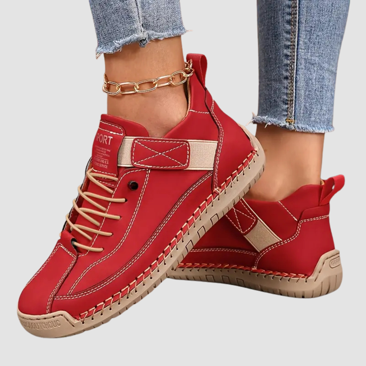 Red stitched sneakers with strap and laces, pair shown on light background
