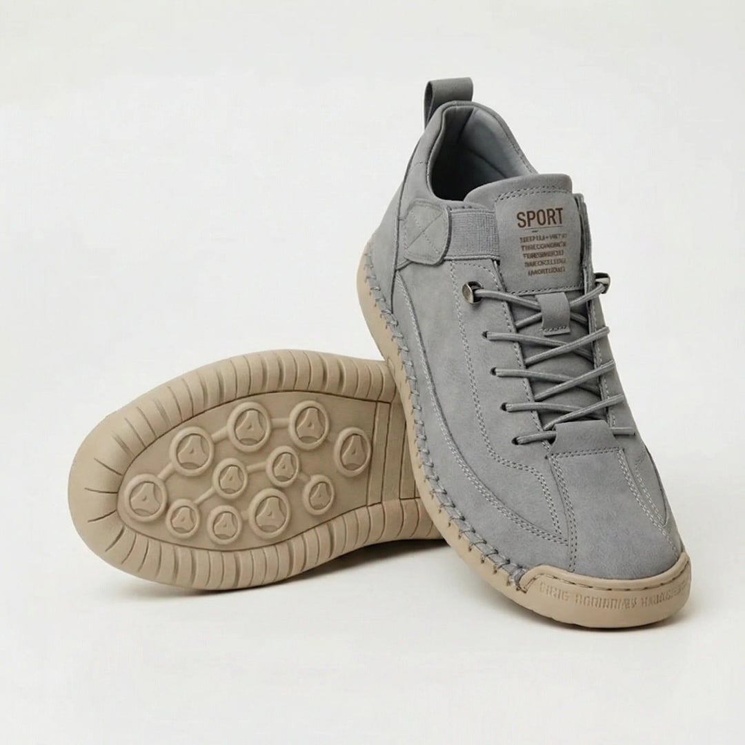 Light gray walking shoes with elastic laces and tan stitched sole, pair view