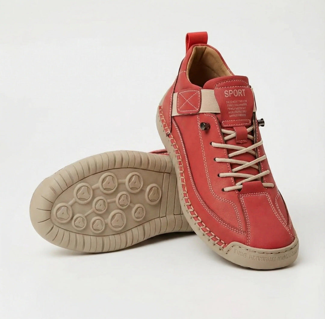 Red walking shoes with white elastic laces and a tan stitched sole