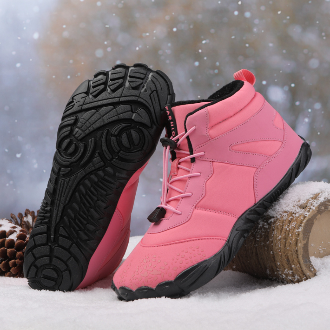 Pair of pink ankle boots with the black flexible tread sole facing up
