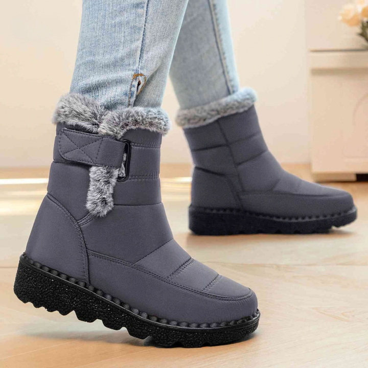 Gray ankle boots with faux fur cuff and quilted strap, worn with light jeans