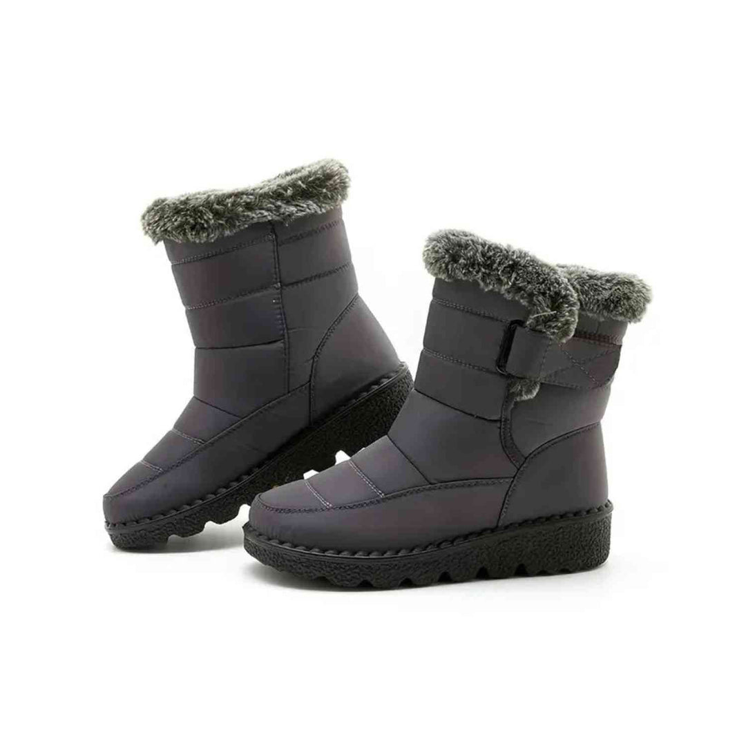 Pair of gray ankle boots with faux fur cuff on a plain white background