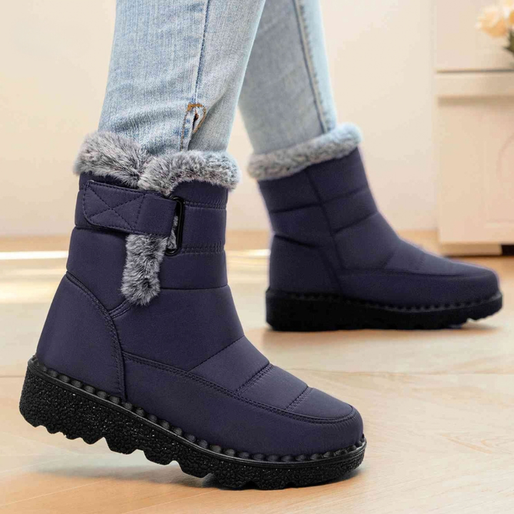 Navy ankle boots with faux fur cuff and strap closure, worn with jeans