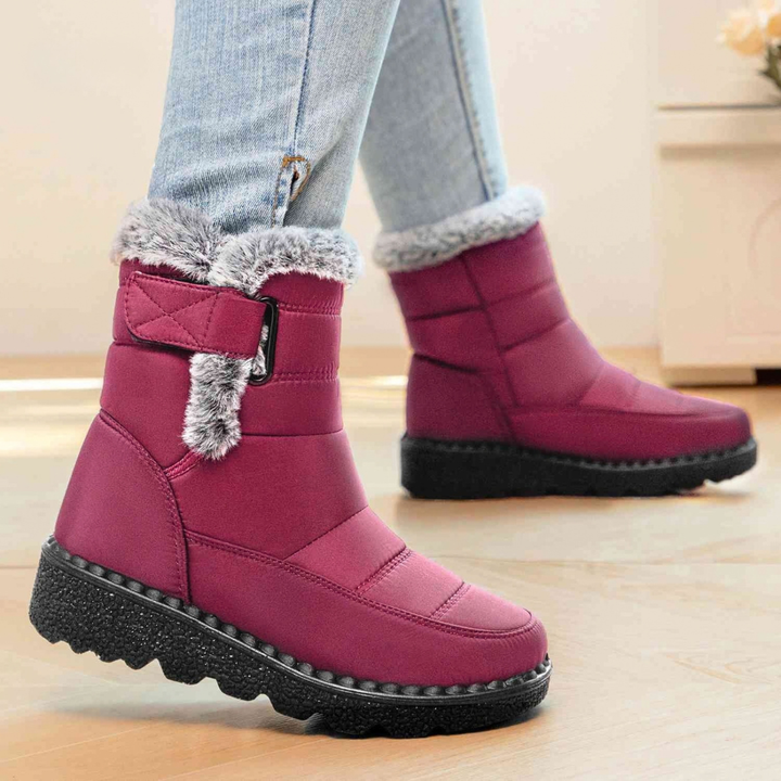 Red faux fur cuff ankle boots with strap, worn with light blue jeans