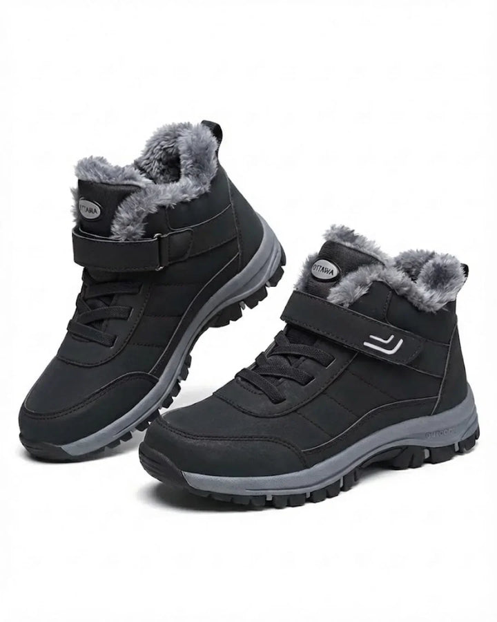 Black ankle hiking boots with fur lining and strap closure, pair view