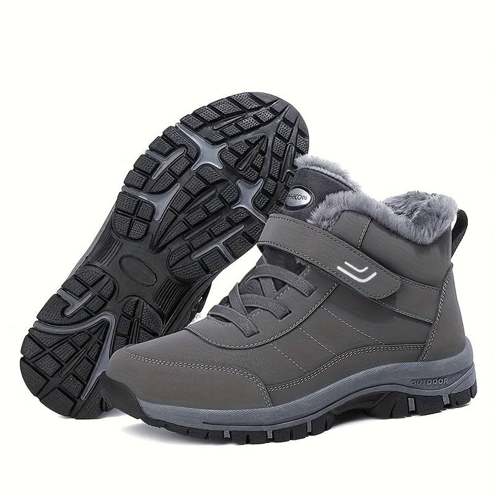 Gray hiking style ankle boots showing the lugged rubber sole and fur collar