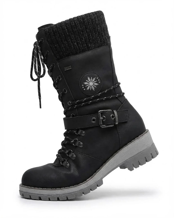 Single black lace up hiking boot with knit cuff, buckle strap and gray sole