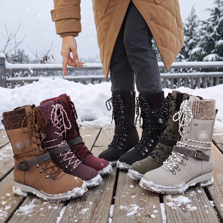 Four colors of lace up knit cuff boots lined up on a snowy deck